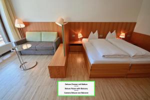 a hotel room with a bed and a couch at Bed & Breakfast Hotel Nives in Solda