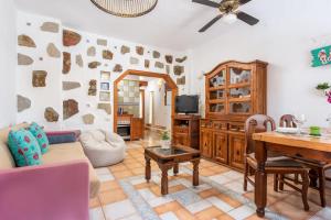 a living room with a table and a couch at Los MOXAICOS, TENERIFE in Costa Del Silencio