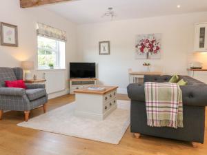a living room with two couches and a tv at The Croft in Ashbourne