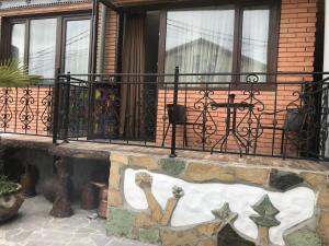 a balcony with a fence and a painting on a wall at The oldest Tbilisi in Tbilisi City