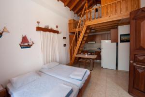a small room with a bed and a staircase at Odyssia in Symi