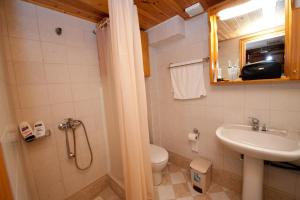 a bathroom with a toilet and a sink at Odyssia in Symi