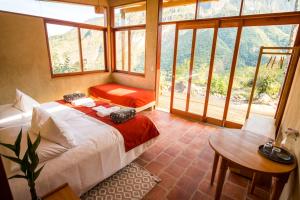 a bedroom with a bed and a table and windows at Goctamarca Lodge in Cocachimba +76 photos