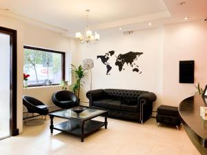 a living room with a black couch and a world map on the wall at Hotel Ramos Mejía in Mar del Plata