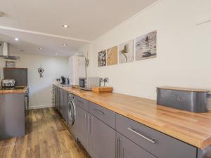 a kitchen with a counter and a washer and dryer at 61 Seatown in Buckie
