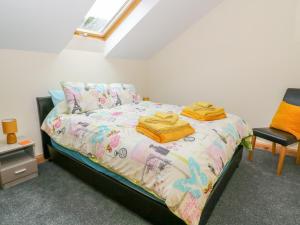 a bedroom with a bed with two towels on it at Croft Cottage in Lancaster