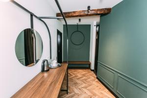a room with a mirror and a wooden table at Atoneli Apartment hotel in Tbilisi City
