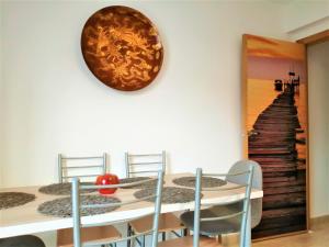 a dining room with a staircase mural on the wall at Unigue Design Apartment, Gandia in Gandía