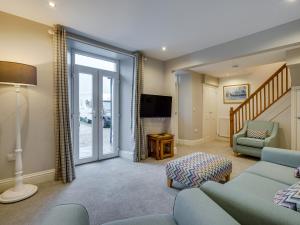 a living room with a couch and a tv at Two Lake View in Coniston