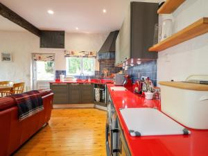 a kitchen with red counter tops and a red counter top at Quiet Waters Cottage in Coleraine