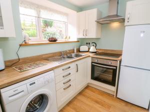a kitchen with a sink and a dishwasher at 2 West Haswicks in Bishop Auckland