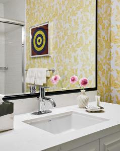 a bathroom with a sink and a mirror at Graduate Columbia, SC in Columbia