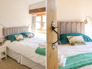 a bedroom with a bed and a window at The Old Smithy in Honiton