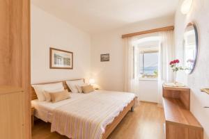 A bed or beds in a room at Apartments Matea - 20m from sea