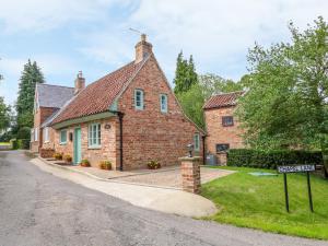 a brick house with a street sign in front of it at Lizzies Cottage in Horncastle