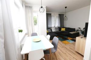 a white table and chairs in a living room at Šamorín - apartment in the center - free parking in Šamorín