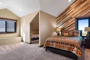 a bedroom with a large bed with a wooden headboard at Raspberry Ridge Lodge in Fish Haven +43 photos
