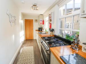 a kitchen with a stove top oven next to a window at Woodlands View Stanhope Castle in Bishop Auckland