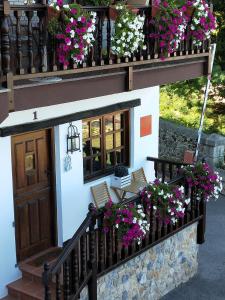 a small house with flowers on a balcony at Las Casucas de Gema in Isla