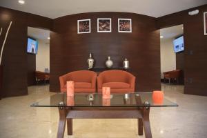 a living room with a couch and a glass table at Hotel River Poliforum in León