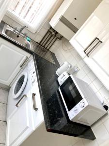 a kitchen with a sink and a stove top oven at AC Lounge 115 in Rochford