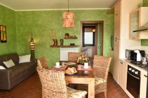 a kitchen and living room with a table and chairs at Holiday Apartment Albachiara in Tavernola Bergamasca +16 photos
