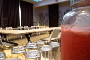 a table with a mason jar of drink in front of a hall at Hotel River Poliforum in León