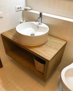 a bathroom with a sink and a toilet at The Suite in Santa Maria Navarrese +6 photos