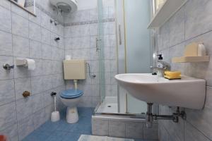 a bathroom with a sink and a toilet at Apartments and Rooms Jakov in Primošten