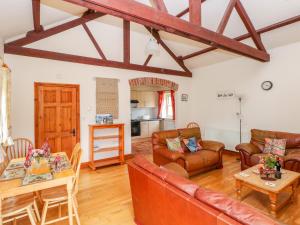 a living room with a couch and a table at Taf Cottage in Carmarthen