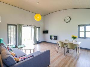 a living room with a couch and a table at Primrose in Glastonbury