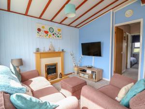 a living room with two couches and a fireplace at Moggs Retreat in Skegness