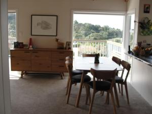 a dining room with a table and chairs and a window at Leigh Panorama B&B in Leigh