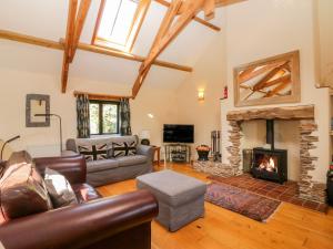 a living room with a couch and a fireplace at Ohope Barn in Kingsbridge