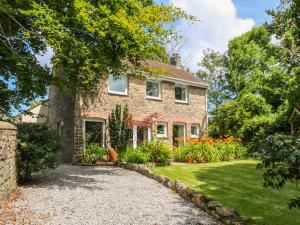 a brick house with a gravel driveway at Coth Skyber in Hayle