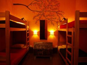 a bedroom with two bunk beds and a tree mural at KACLLA, The Healing Dog Hostel in Lima