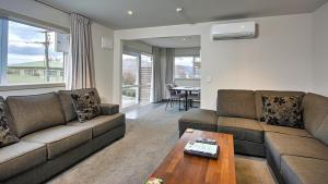 sala de estar con sof&aacute; y mesa en Autoline Queenstown Motel en Queenstown