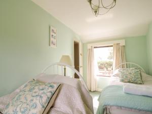 a bedroom with a bed and a window at 1 Pennine View in Long Marton