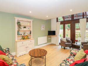 a living room with a couch and a table at The Forge in Winscombe