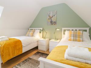a bedroom with two beds and two night stands at The Forge in Winscombe
