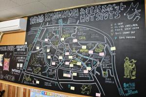 a chalkboard with a map ofhot spots on a wall at Beppu Kannawa Onsen HIROMIYA in Beppu