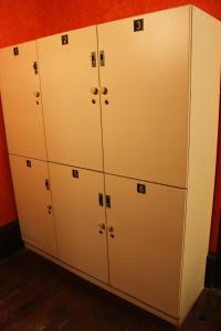 a row of white lockers in a room at KACLLA, The Healing Dog Hostel in Lima