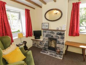 a living room with a fireplace and a mirror at Ael Y Bryn in Menai Bridge