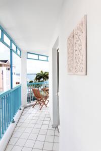a balcony with a door and a view of the ocean at Ocean View and Exclusive Flat Le croisieriste in Pointe-à-Pitre