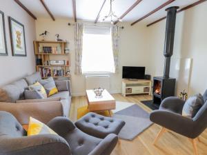 a living room with a couch and a fireplace at Grebe Cottage in Oban