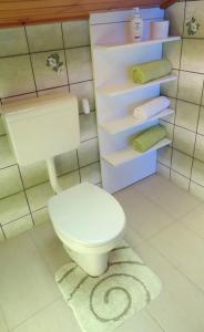 a bathroom with a white toilet and some towels at Apartments Horvat in Crikvenica