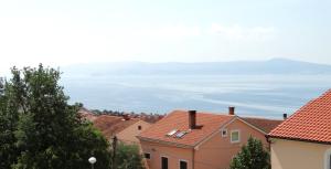 a view of the ocean from the roofs of houses at Apartments Horvat in Crikvenica