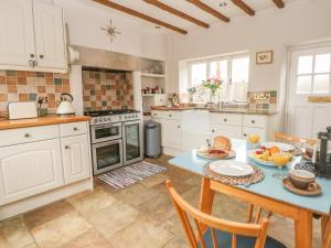 a kitchen with a table with food on it at Cutlers Cottage in Matlock