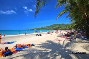 a group of people laying on the beach at Bungalow Apartment Kamala in Phuket