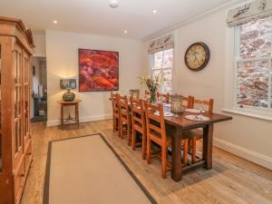 a dining room with a wooden table and chairs at 11 Marine Terrace in Criccieth